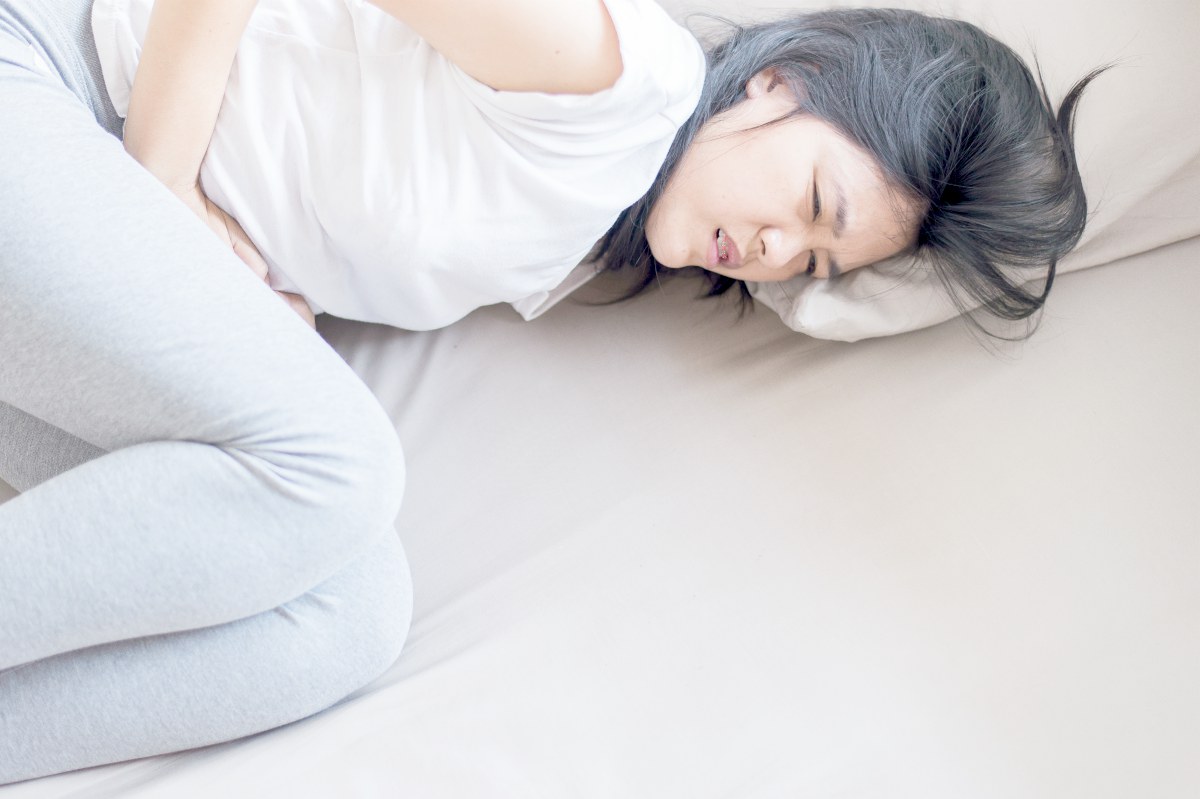 woman having stomach ache | Alkaline Water For Acid Reflux | symptoms of acid reflux
