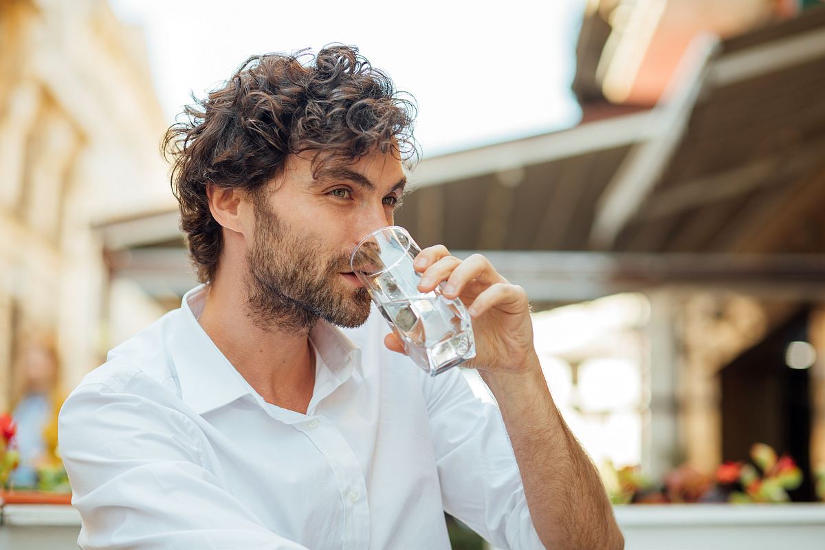 Young masculine man drinking water | Introducing Your Body To Alkaline Water | alkaline water benefits