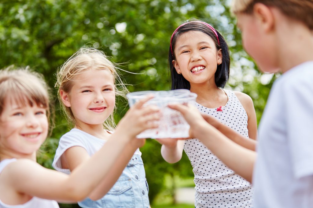 children enjoying healthy water from a water ionizer