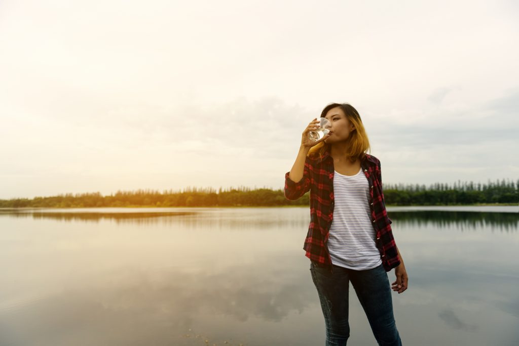 Beautiful young woman drinking water - beautiful happy woman enj