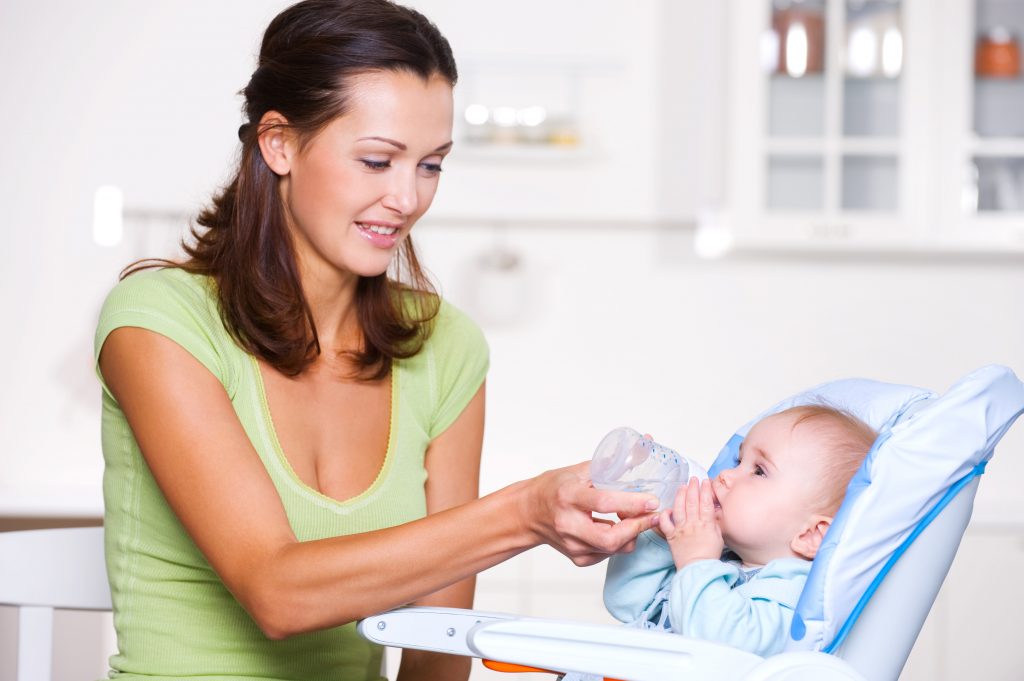 Mother giving the water to  baby