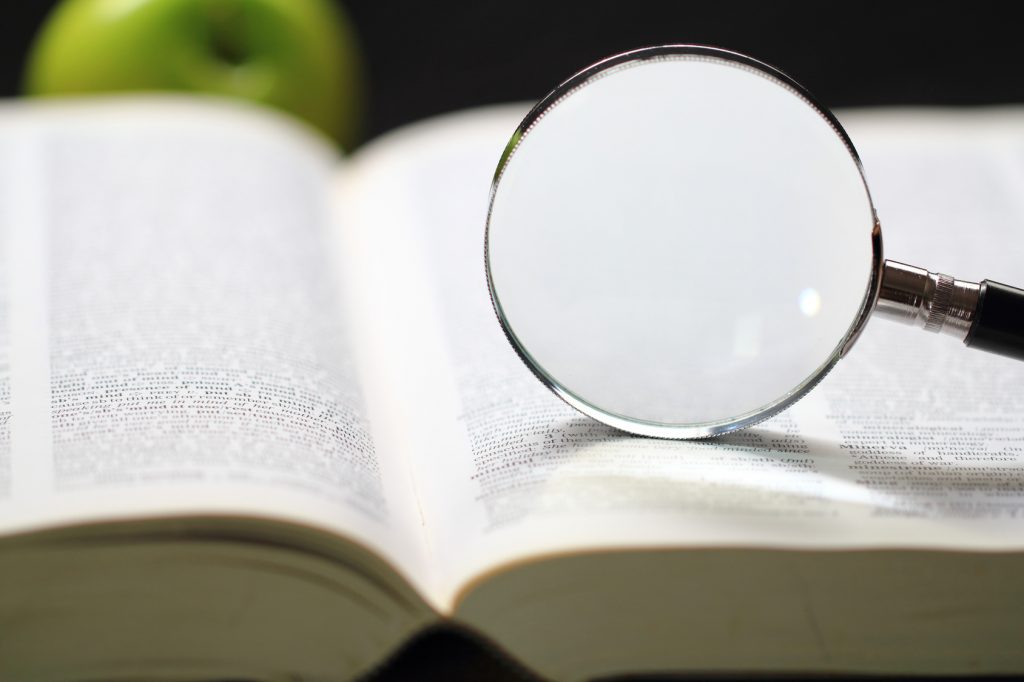 Dictionary and magnifying glass