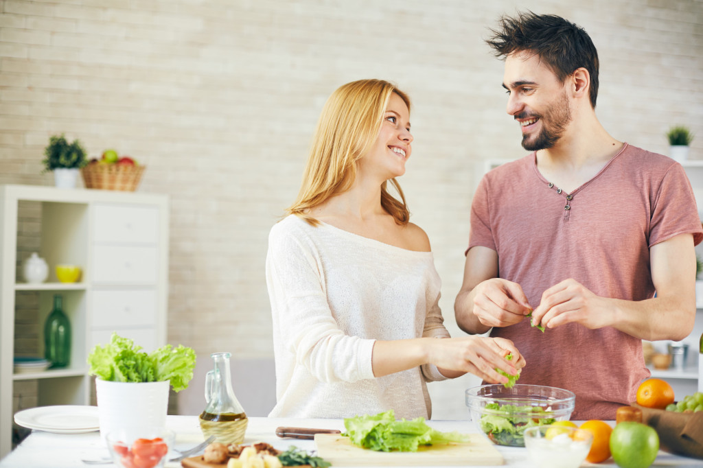 Young couple cooking breakfast together