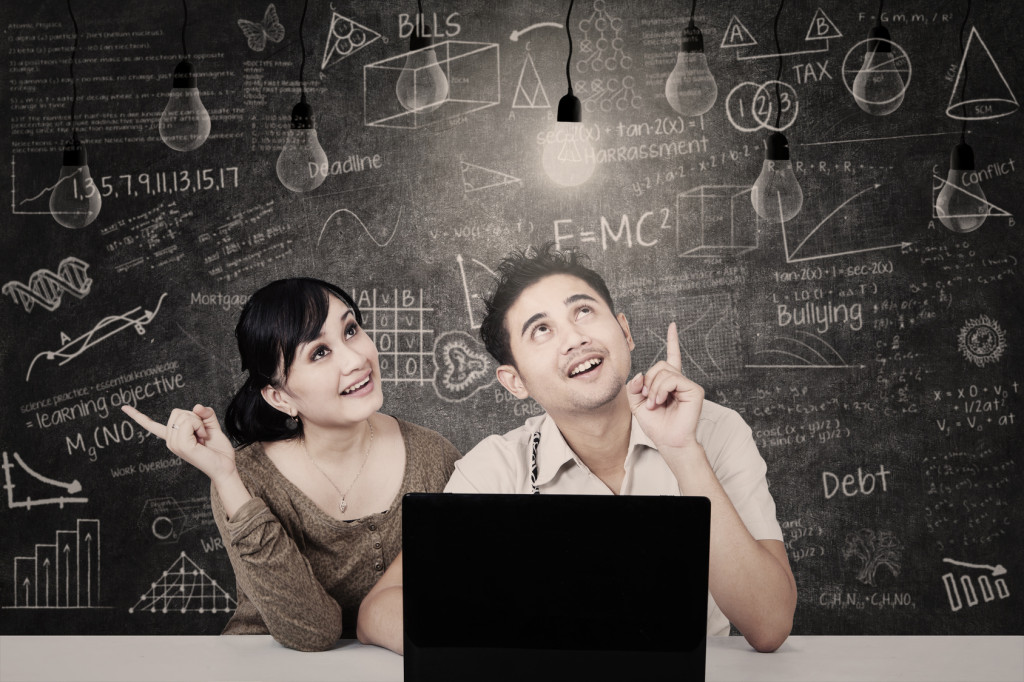 Couple looking at solution light bulbs in class