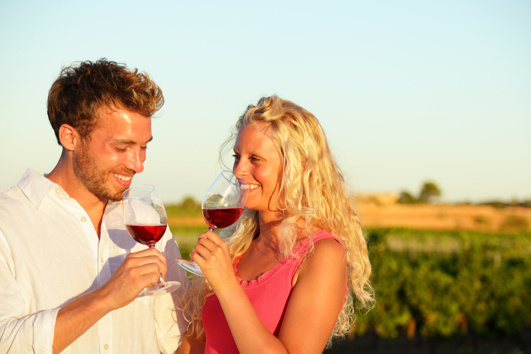 Drinking red wine couple at vineyard