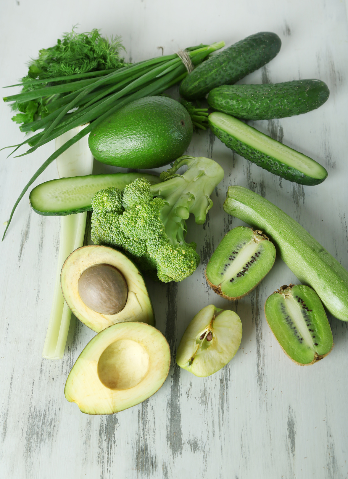 Fresh green vegetables and fruits, on wooden background