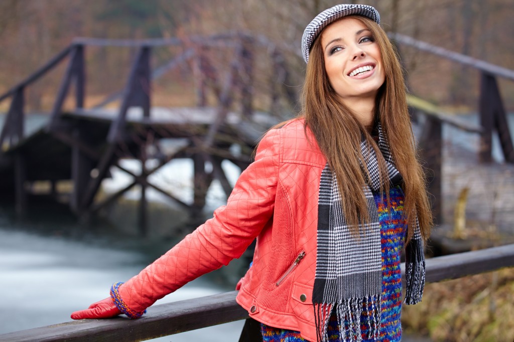 Portrait of a beautiful brunette girl in in park. Warm sunny da