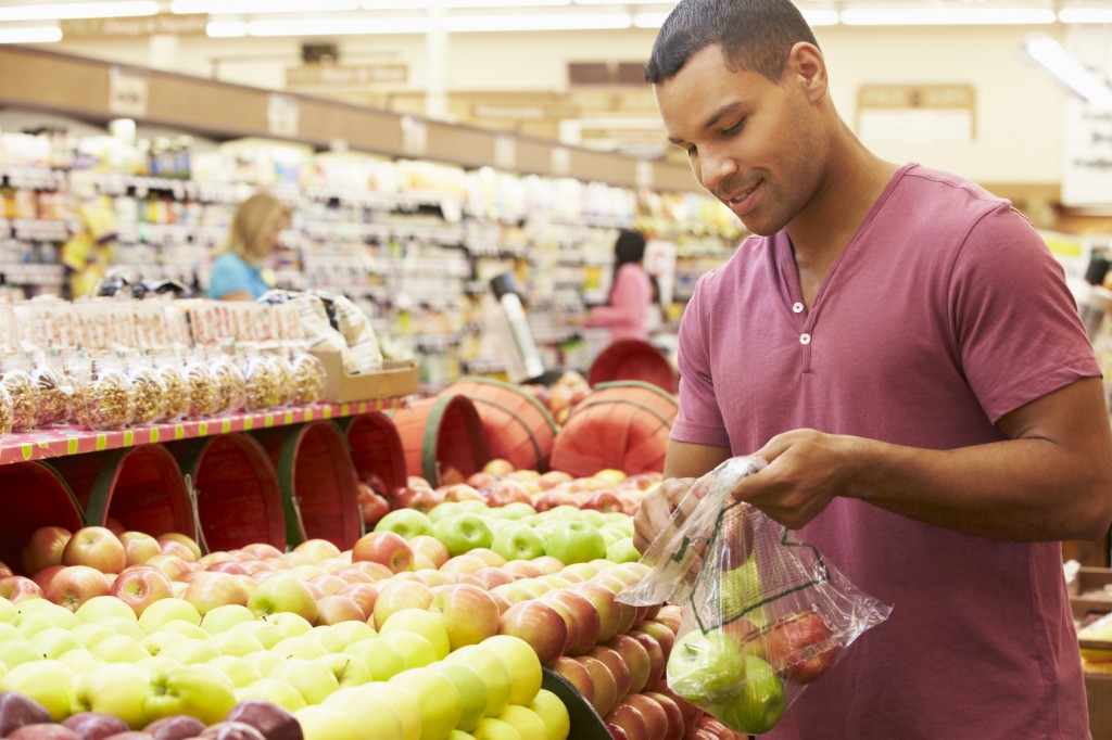 Man At Fruit Counter In Supermarket