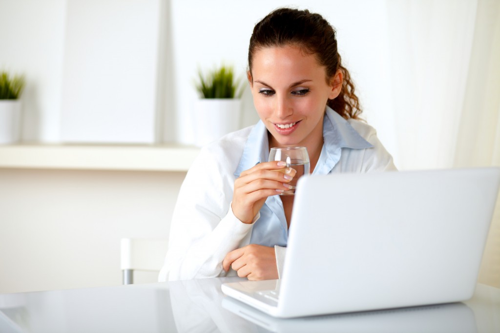 Charming female drinking a glass of water