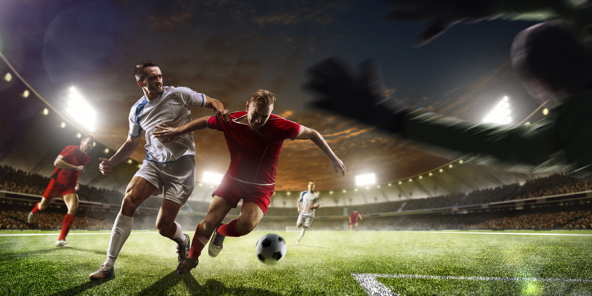 Soccer players in action on sunset stadium background panorama