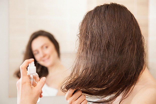 Smiling Young woman applying hair spray | Beautiful | Beauty water for hair treatment | Reasons To Love Tyent Water Ionizers