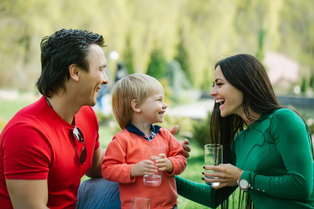 Happy family with water glass