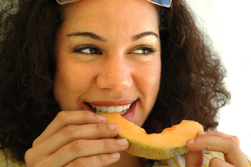 young woman with a cantaloupe