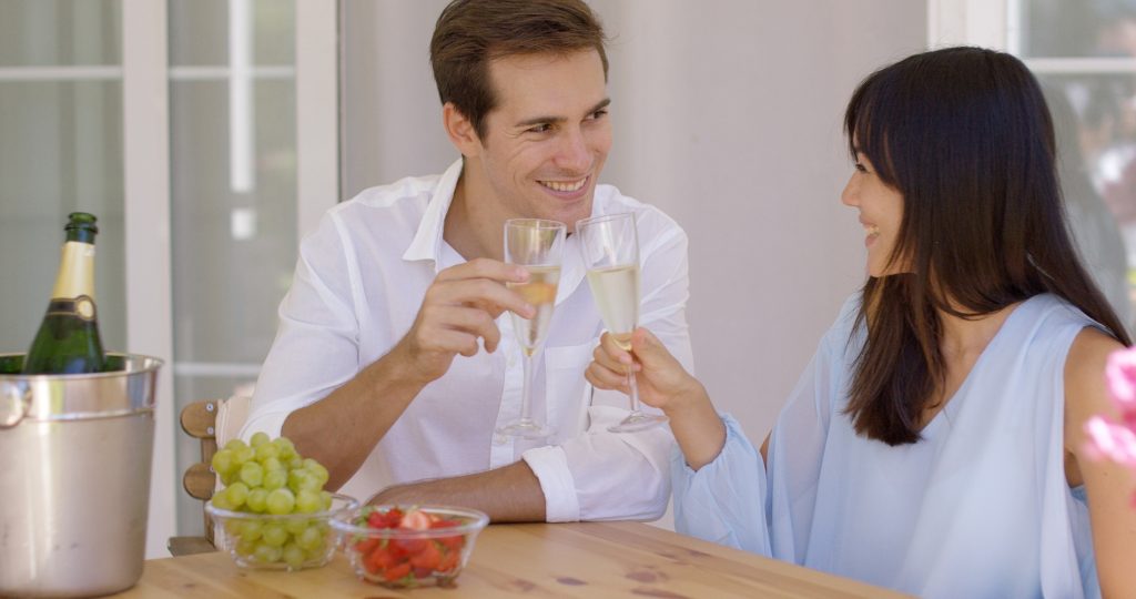 Cheerful couple toasting champagne