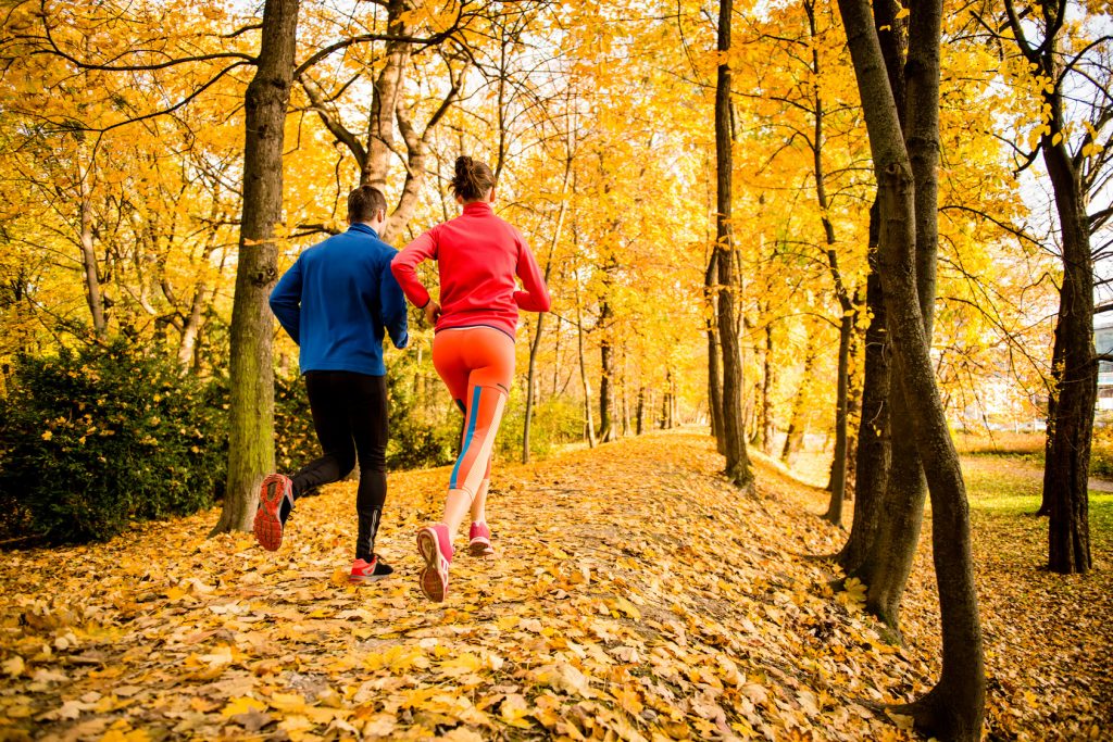 Couple jogging in autumn nature