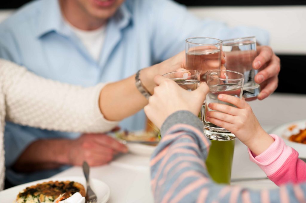 It's time to celebrate. Family toasting with water!