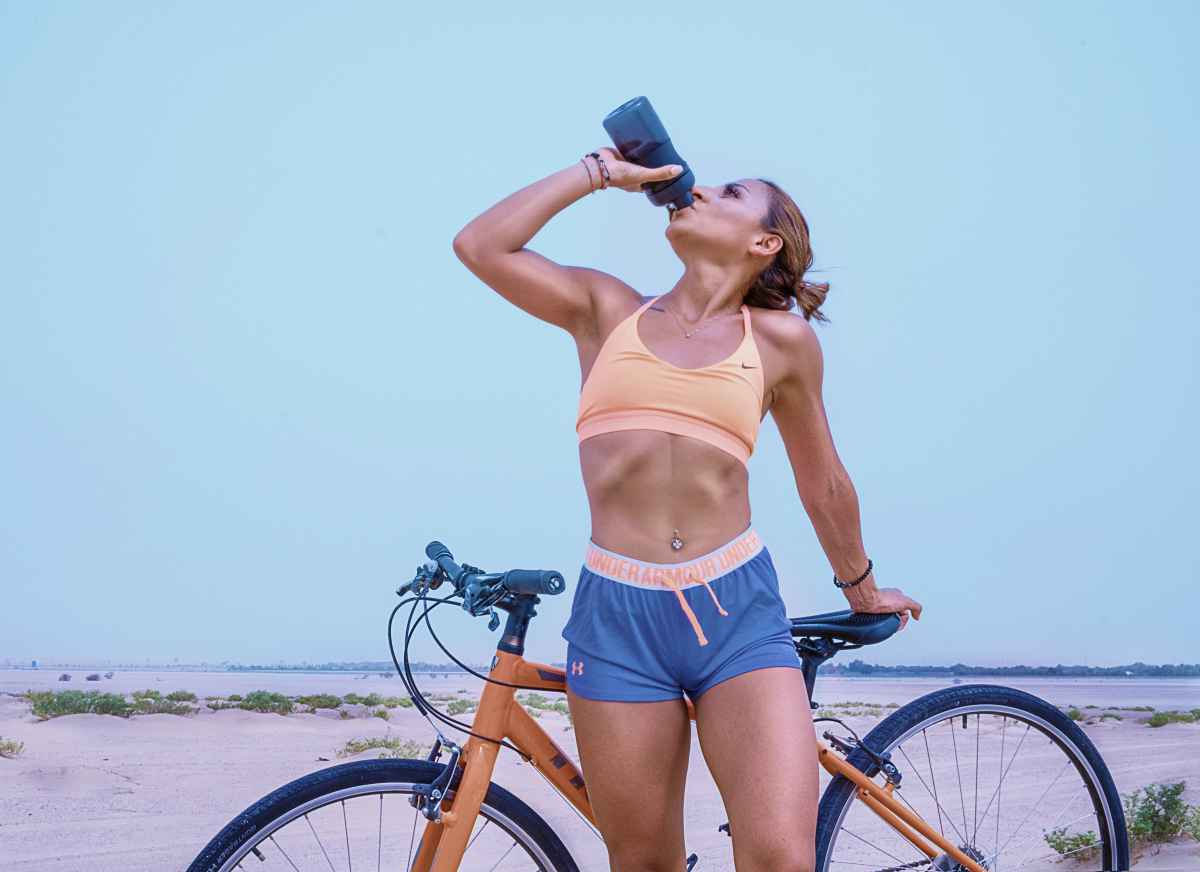 woman drinking water with her bicycle | Reasons to Love Tyent Water Ionizers, Part 6: Sports
