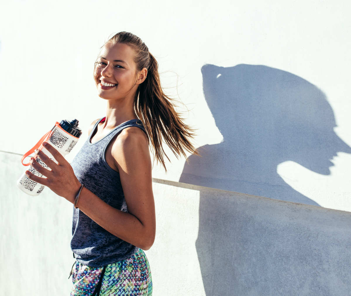 Beautiful female runner standing outdoors | Antioxidants and Its Benefits | Alkaline Water and Antioxidants