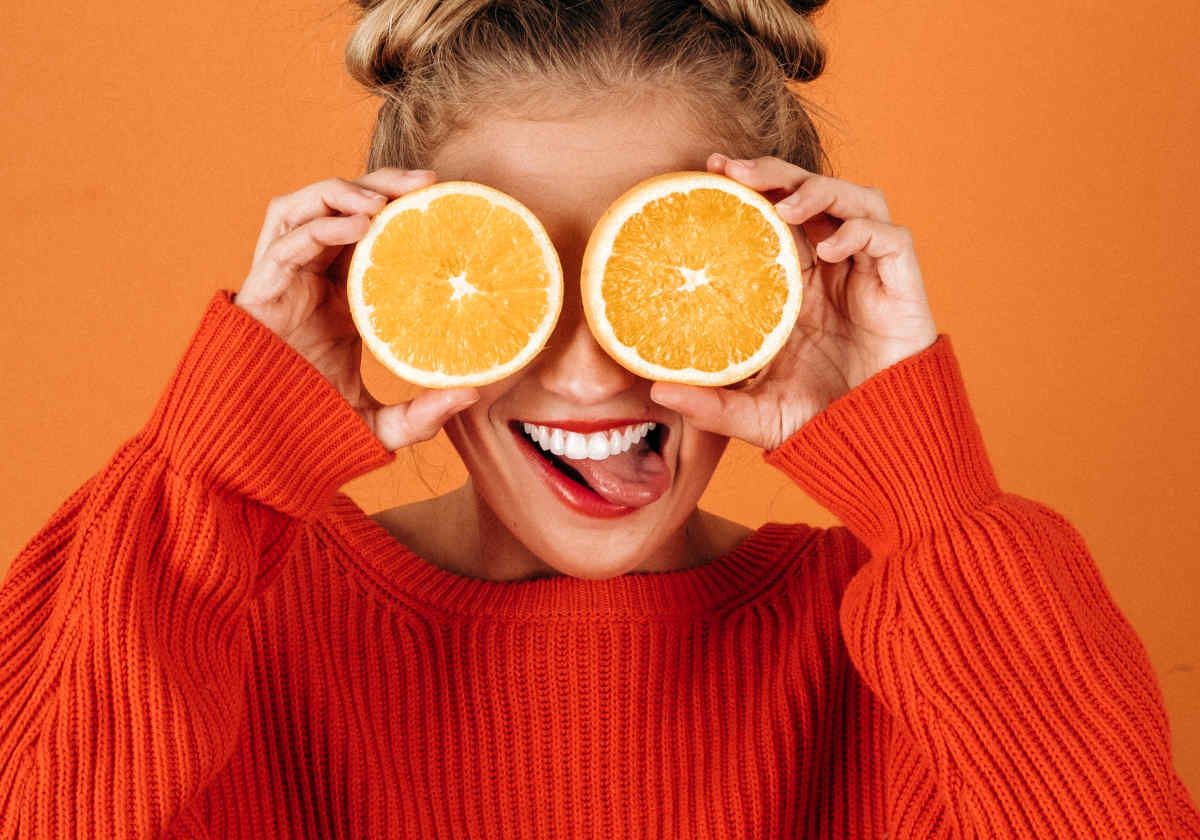 Lady holding a sliced Oranges | Fruits and Veggies That Can Keep You Hydrated
