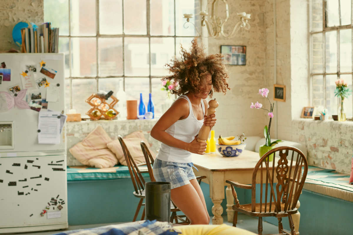 Happy curly haired girl dancing kitchen | Morning Routine Hacks That Will Make Life Easier