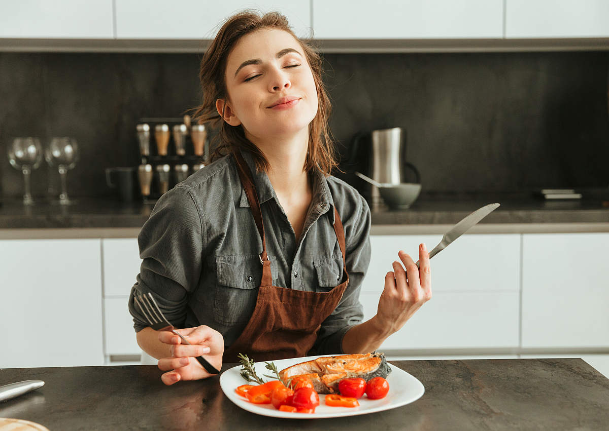 Pretty young woman sitting kitchen | Everything You Need To Know About Healthy Eating