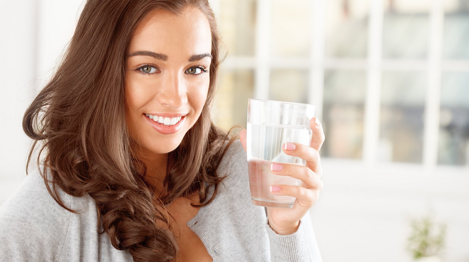 Feature | Woman holding a glass of water | Tyent Alkaline Water Ionizer Company Has Much to Offer You