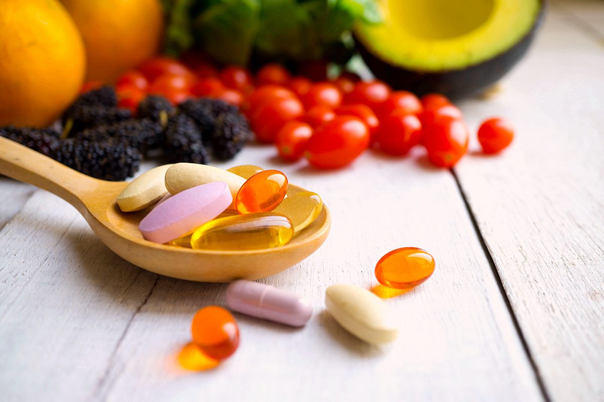 Pills, Capsules with Wooden Spoon and Fresh Fruits | Take Multivitamins | Ways to Restore Your Body's pH Balance