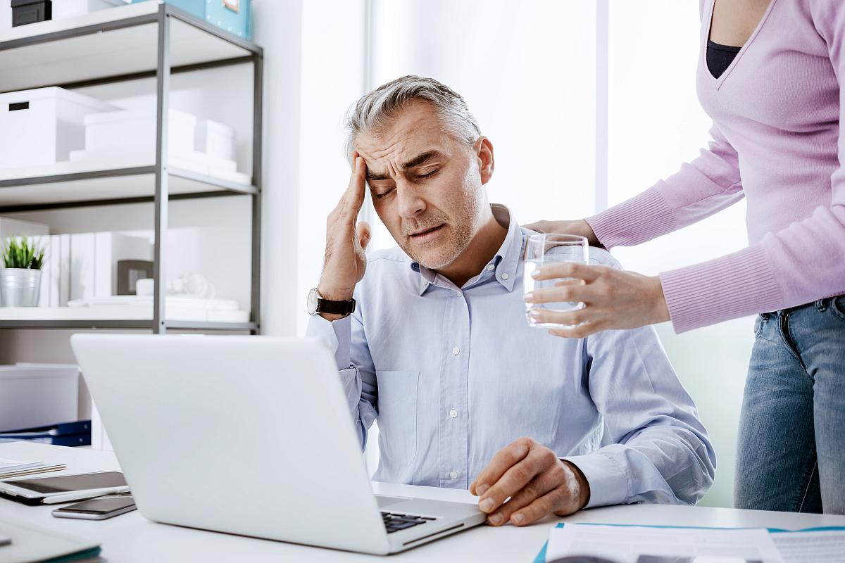 Tired businessman office working desk having headache | Benefits Of Drinking Water