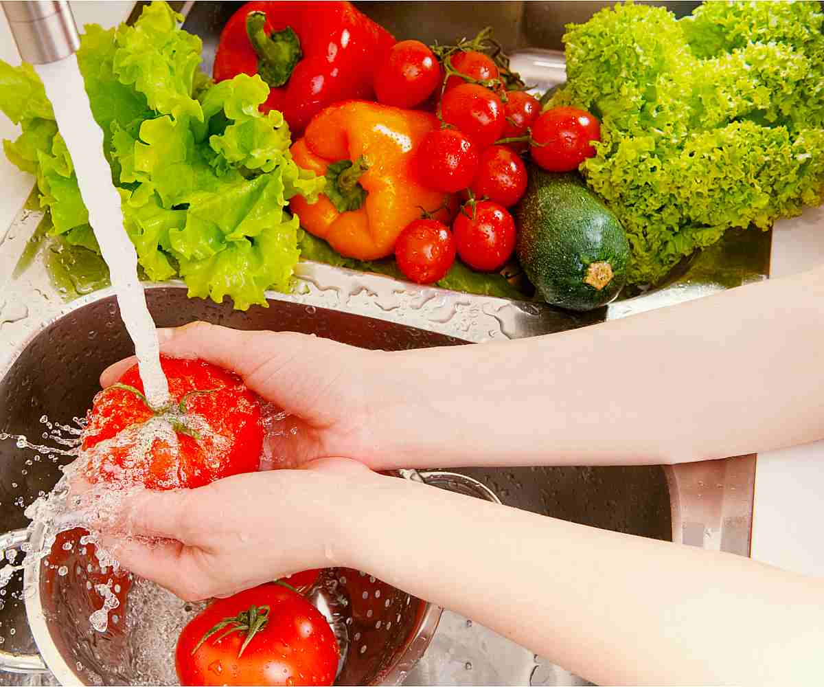 Fresh vegetables under water stream in colander | Kitchen Hacks Using Alkaline Water