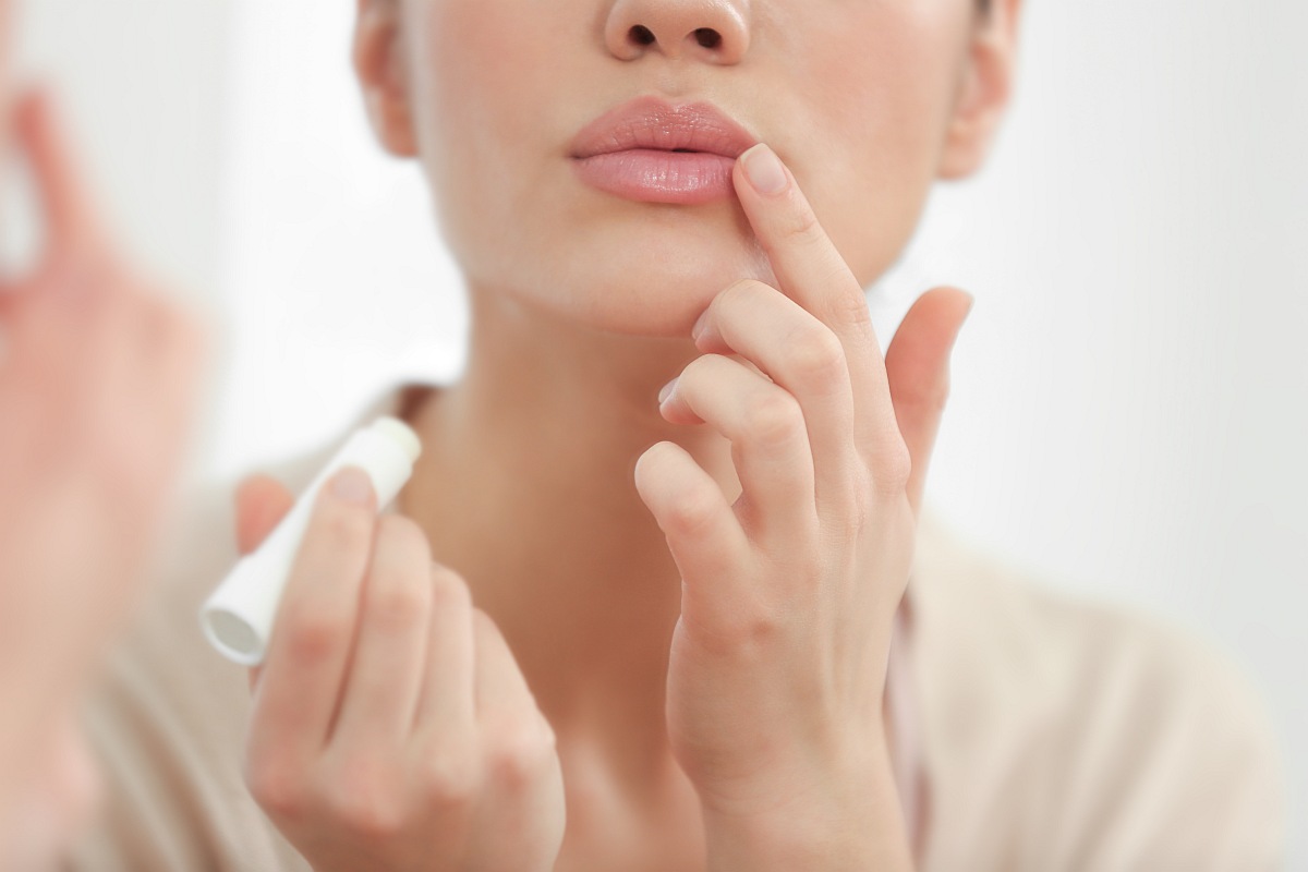 Woman applying lip balm | Surprising Benefits Of Baking Soda