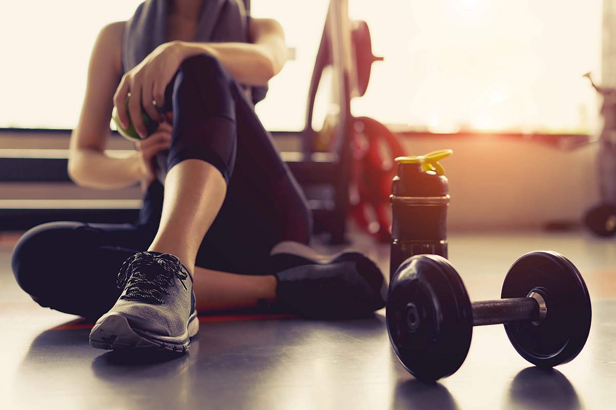 Woman taking a break in the gym | The Importance Of Good Hydration When Working Out