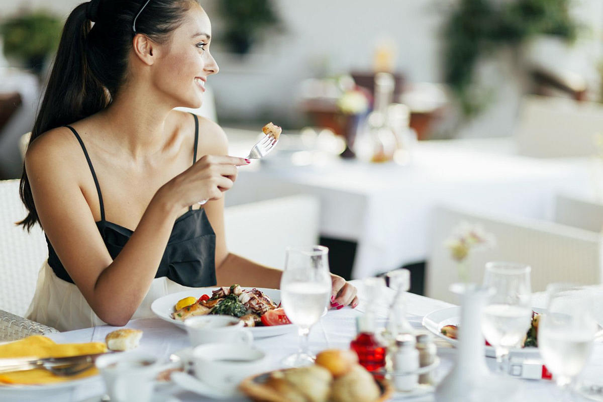 Beautiful woman eating meal restaurant | Hacks to Stay Hydrated