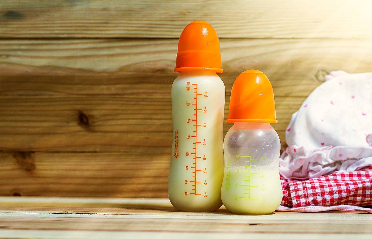 milk bottle on wooden background | When to Give a Baby Water