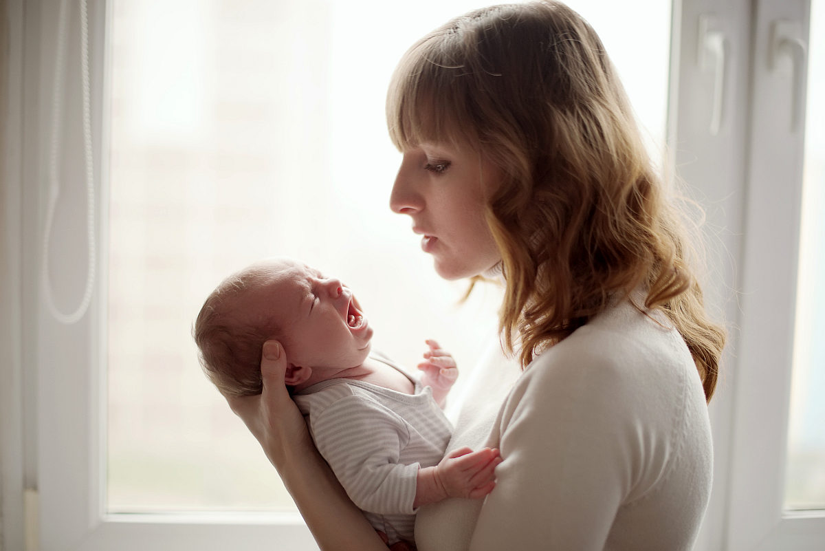 Young woman crying baby | Is Chlorine Safe for Babies?