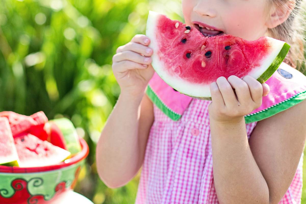 girl eating watermelon | Constipation In Children: 10 Alkaline Foods To Relieve It | chronic constipation in children