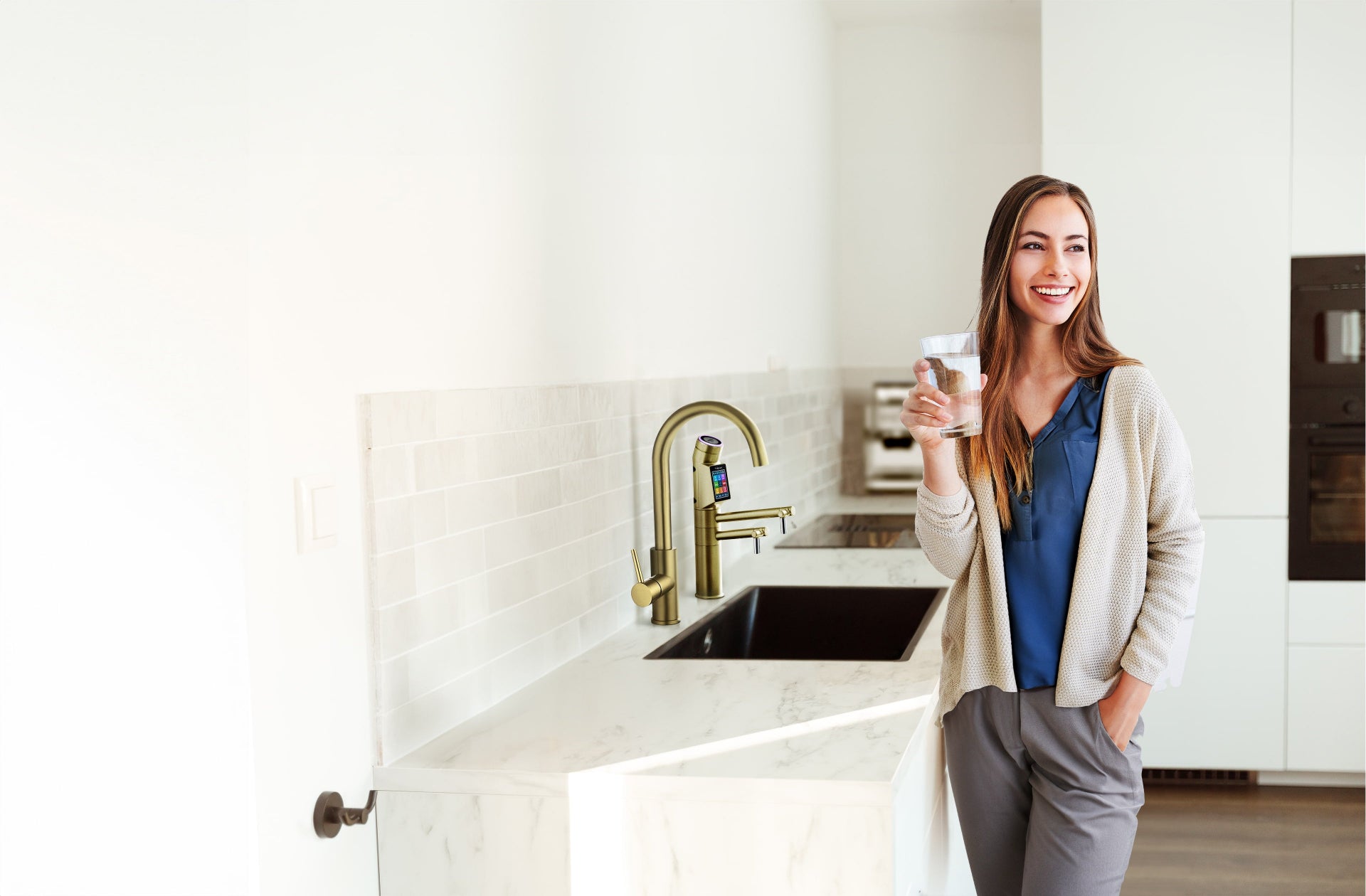 Young Woman Enjoying Tyent Water Ionizer in Modern Kitchen