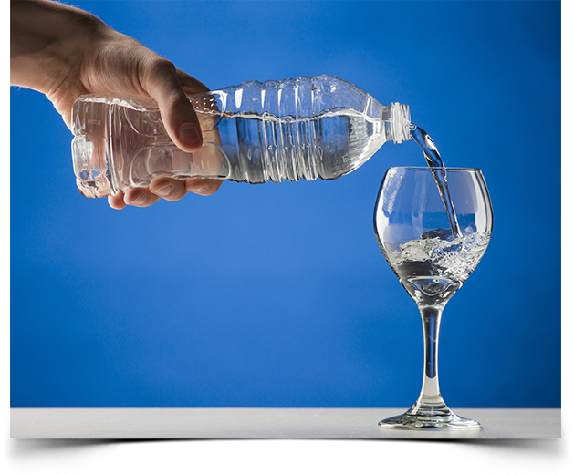Pouring bottled alkaline water into a wine glass