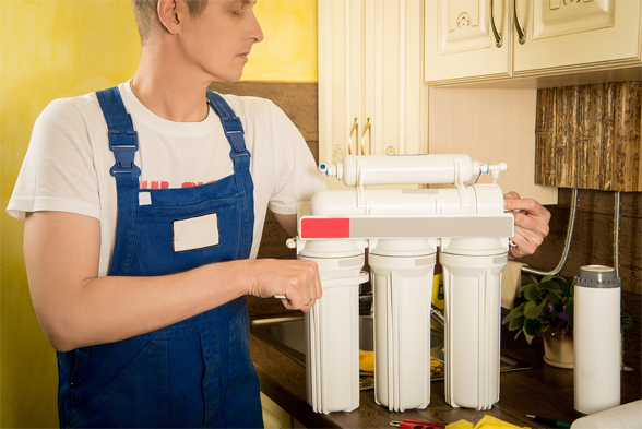 Plumber installing filtered water system