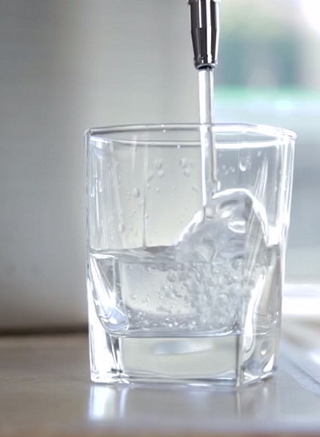 Ionized water in glass with ice